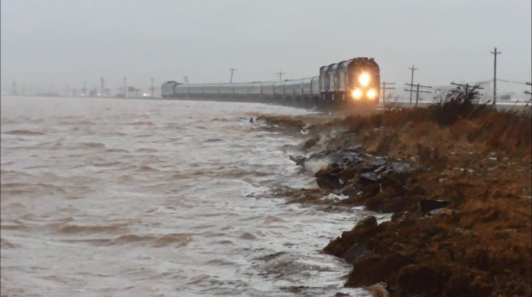 Waves washing against the rail line beside the Tantramar marsh